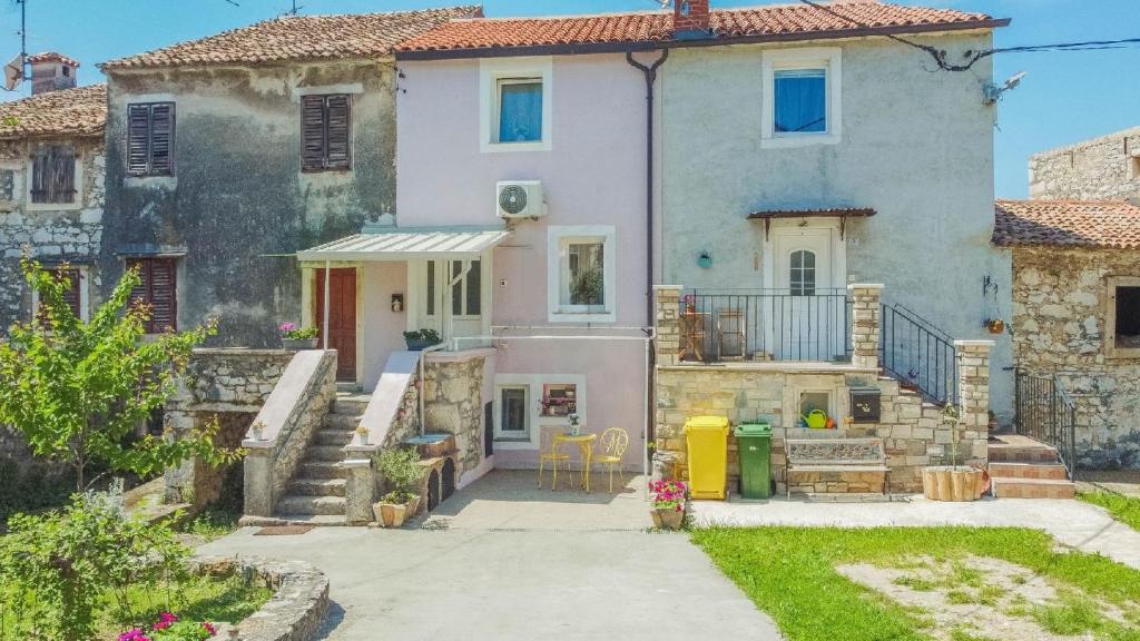 a large white house with a staircase in front of it at House Leon in Brtonigla