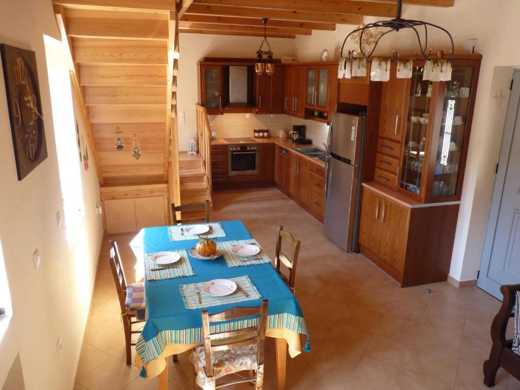 a kitchen with a table with a blue table cloth at Viva Elafonisi in Plokamianá