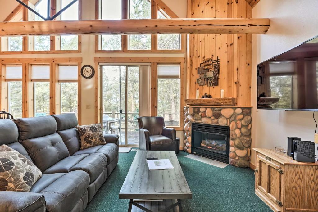 a living room with a couch and a fireplace at Chalet at Running Y Resort w/ Wraparound Deck! in Klamath Falls