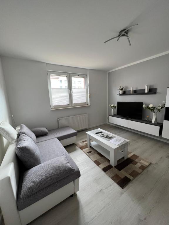 a living room with a couch and a coffee table at Ferienwohnung Sandmann in Greifswald