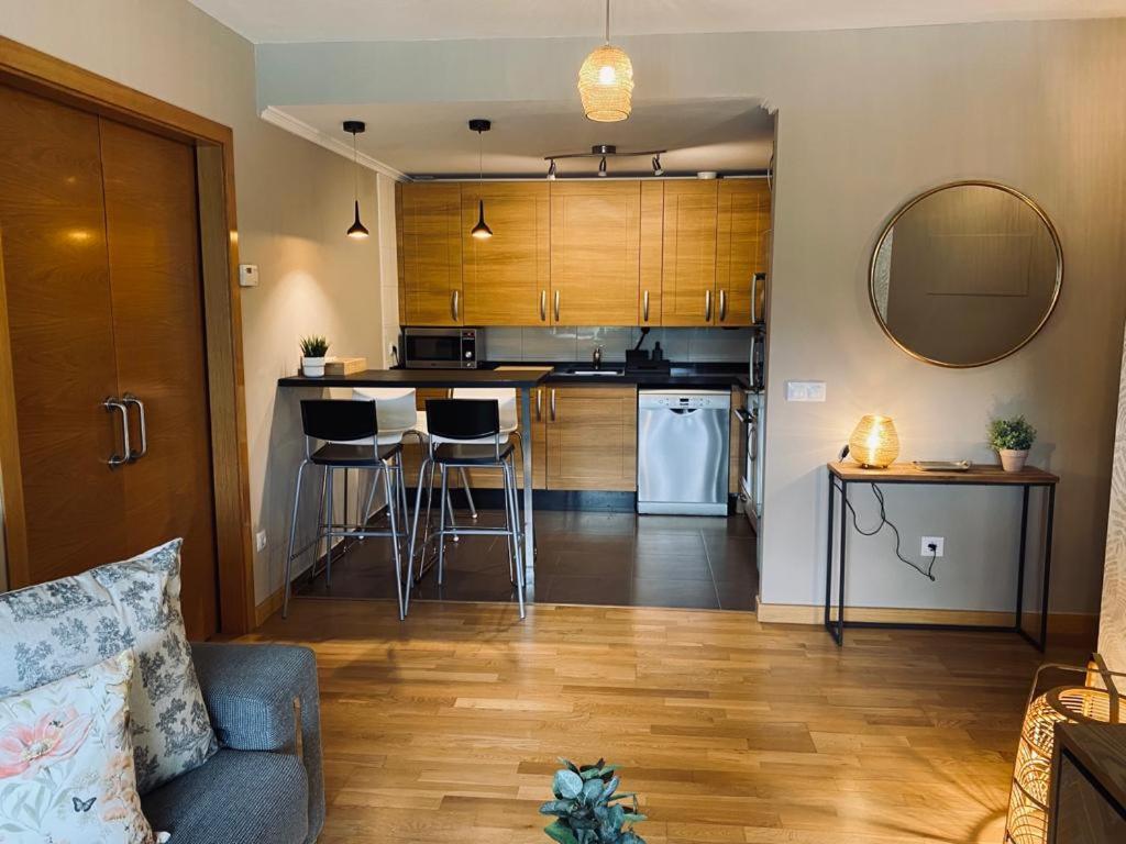 a living room with a couch and a kitchen at Apartamento Aldeana in Llanes