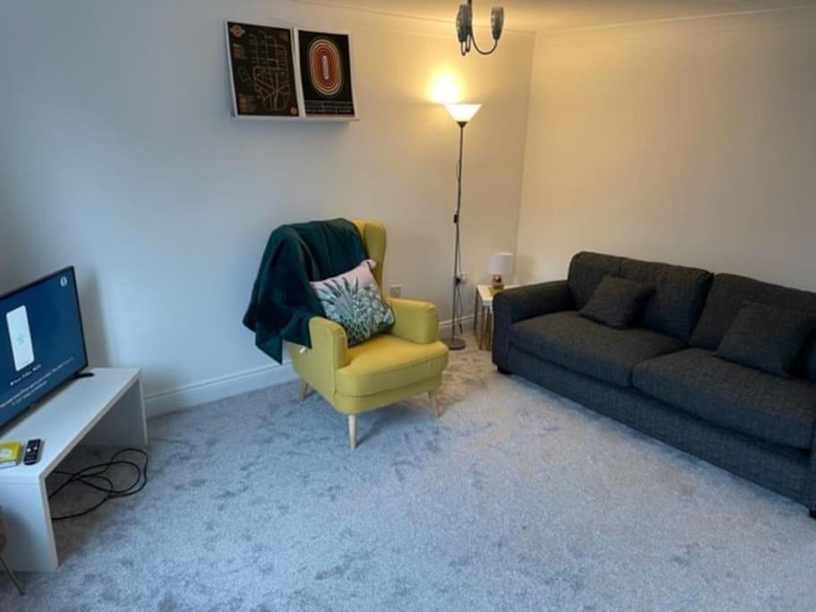 a living room with a couch and a chair at *BRAND NEW* renovated 3 bed with parking & WIFI in Corby