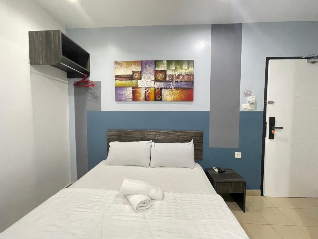 Postel nebo postele na pokoji v ubytování MR Homestay HotelStyle Room Teluk Intan