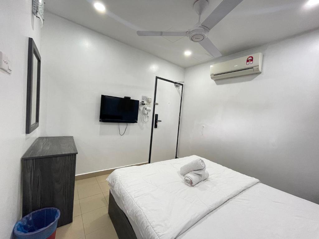 Postel nebo postele na pokoji v ubytování MR Homestay HotelStyle Room Teluk Intan