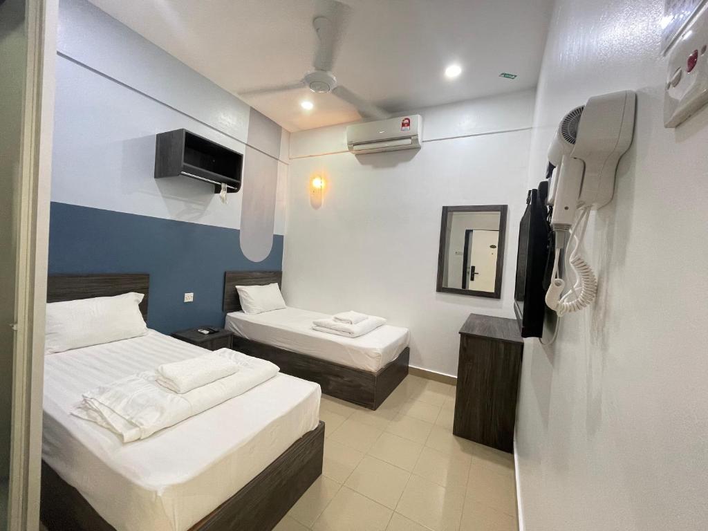 Postel nebo postele na pokoji v ubytování MR Homestay HotelStyle Room Teluk Intan