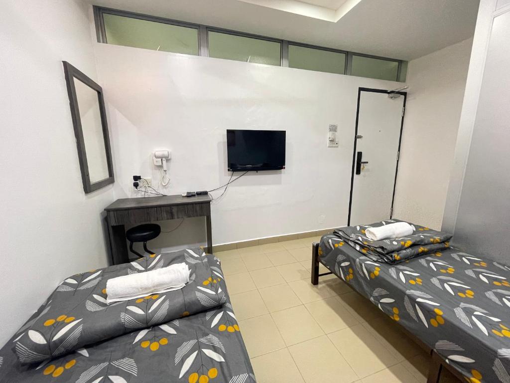 Postel nebo postele na pokoji v ubytování MR Homestay HotelStyle Room Teluk Intan