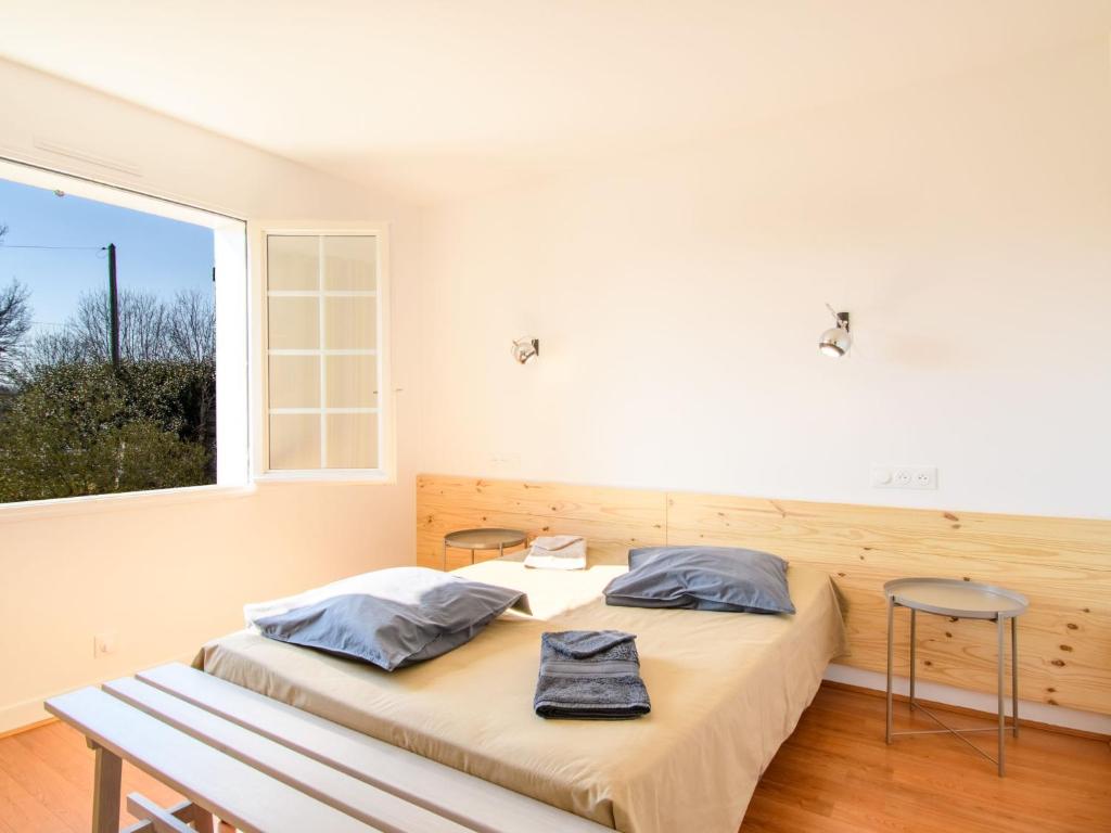 a bedroom with a bed and a large window at Holiday Home Les Chênes by Interhome in Lit-et-Mixe