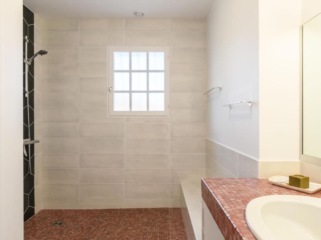 a bathroom with a sink and a shower at Holiday Home Les Chênes by Interhome in Lit-et-Mixe