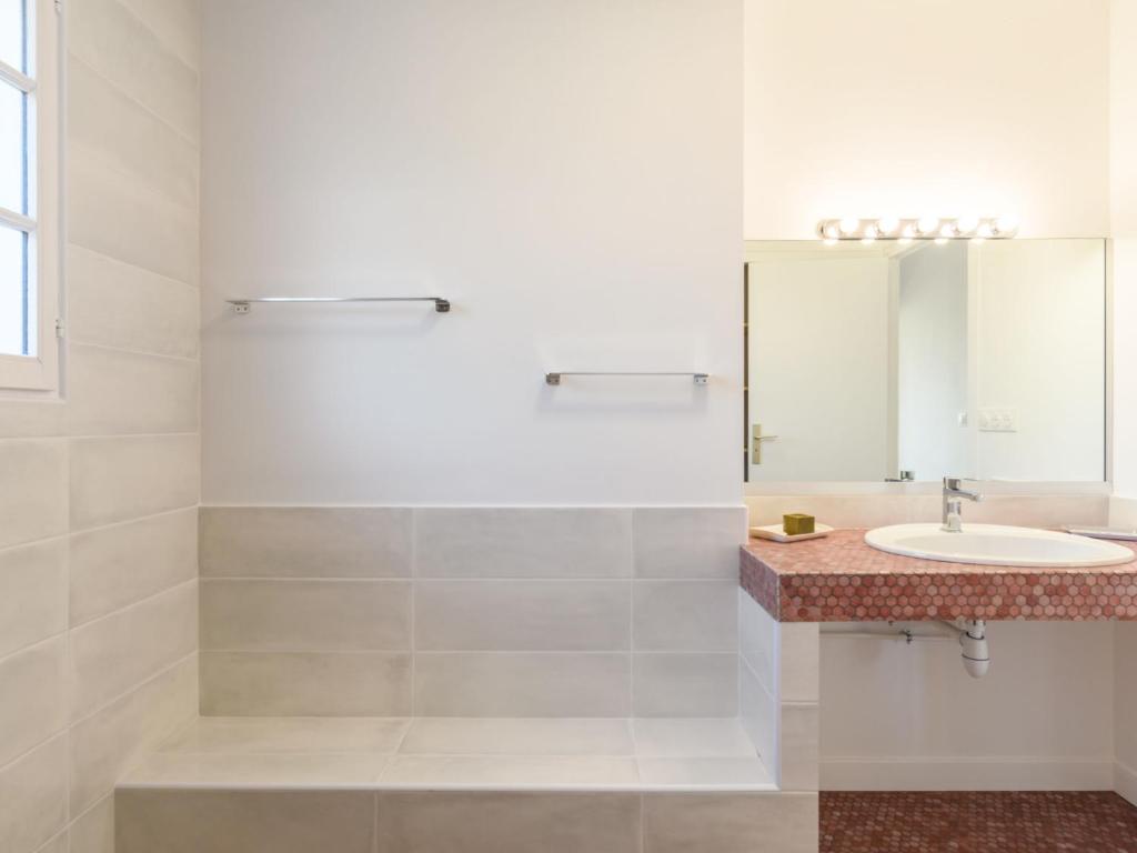 a bathroom with a sink and a mirror at Holiday Home Les Chênes by Interhome in Lit-et-Mixe