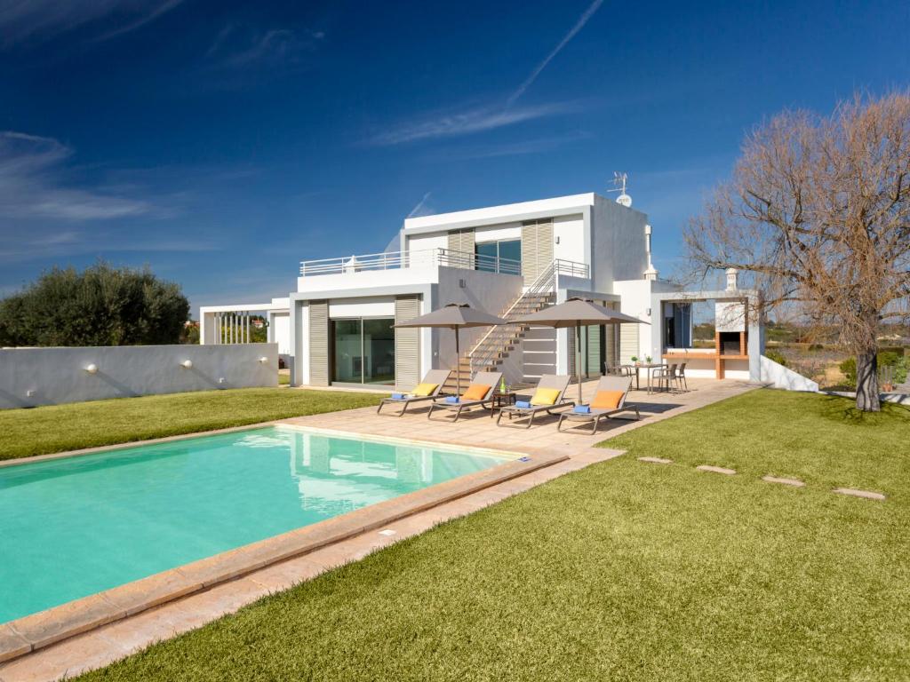 a house with a swimming pool in the yard at Villa Almond Tree by Interhome in Porches