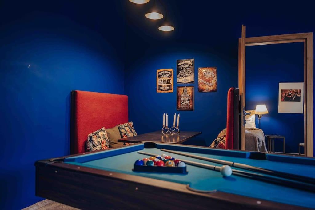 a room with a pool table and a red chair at Unique apartment with private pool, cinema, SPA in Prague