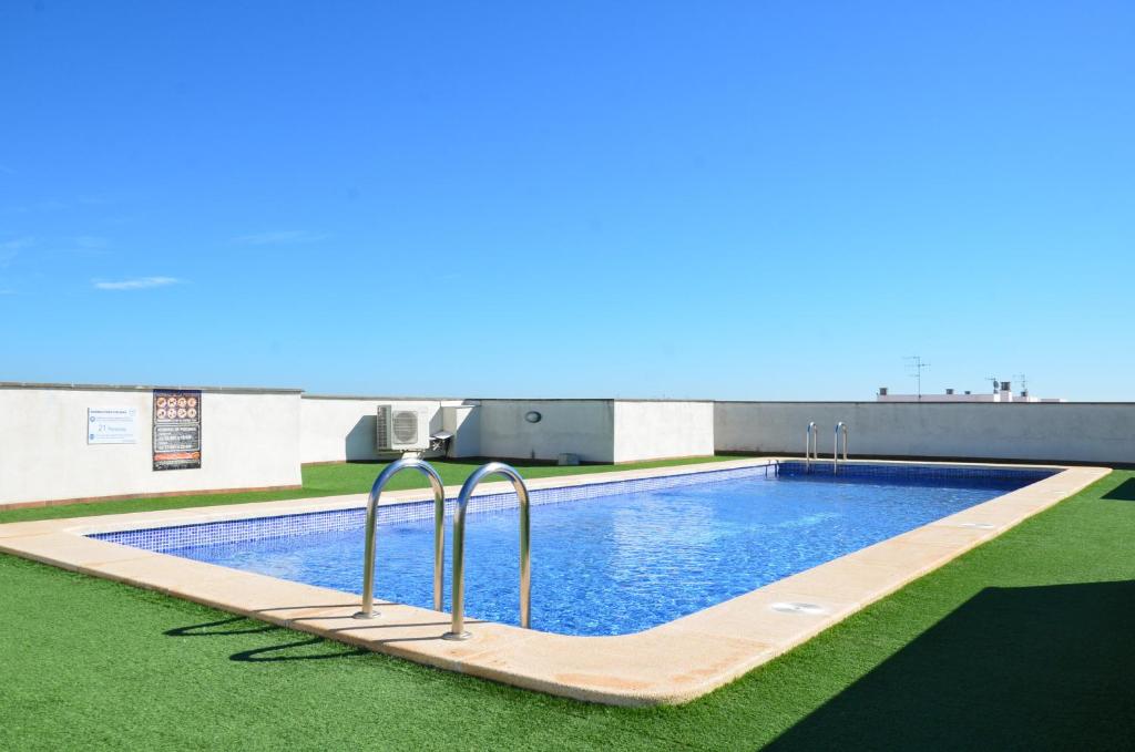 a swimming pool on the roof of a building at FeWo - Moncofa Apartment in Moncófar