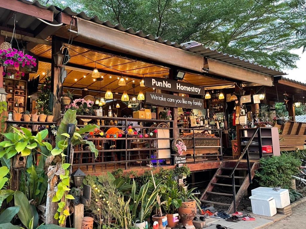 a store with a bunch of plants in front of it at PunNa Homestay @ Bangsai in Ban Bang Sai