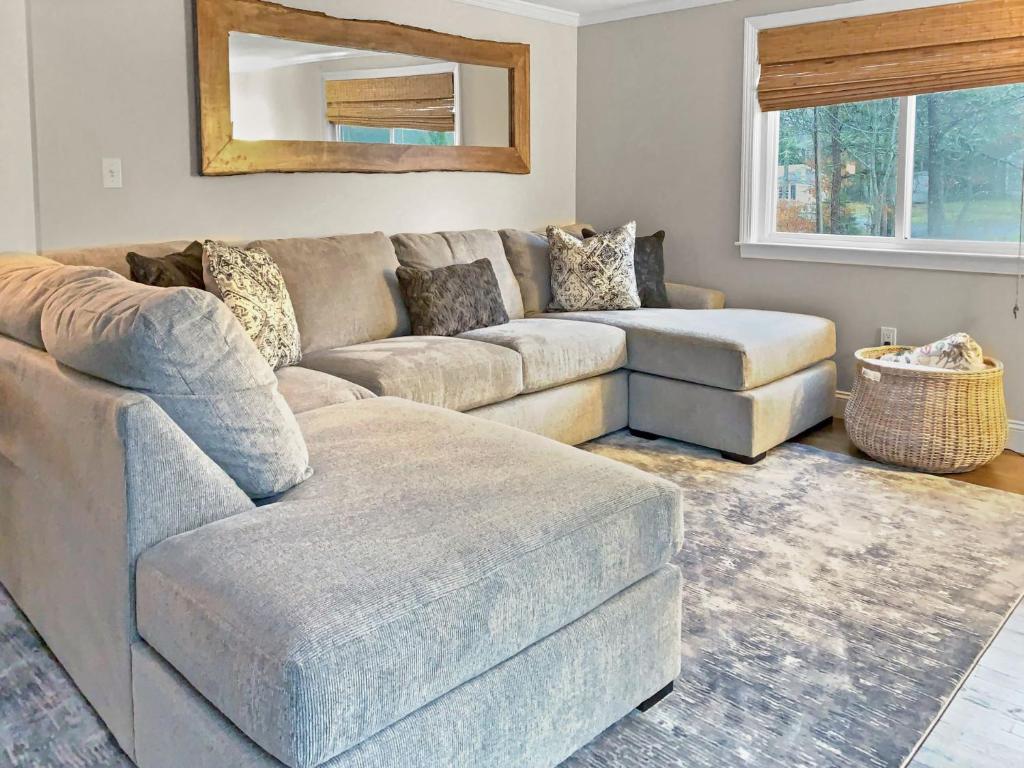 a living room with a couch and a ottoman at 10 Seventh Street Harwich Cape Cod- -Cape Vista in Harwich