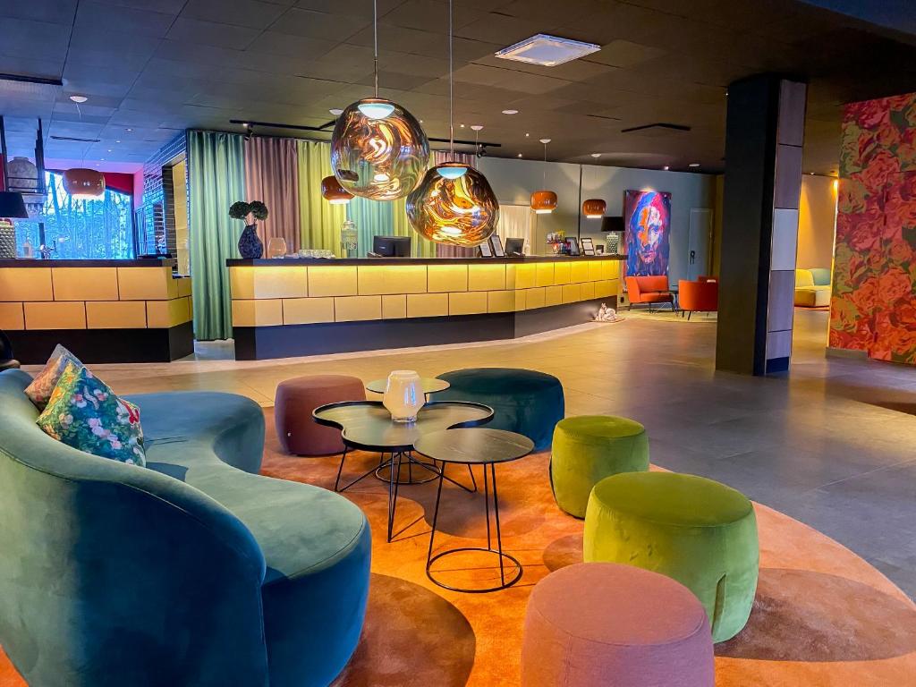 a lobby with chairs and tables and a bar at ProfilHotels Nacka in Stockholm