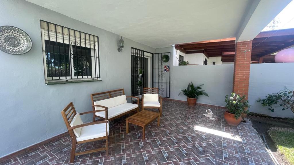 a patio with chairs and a couch on a house at Casa Sol & Mar, Rincon de la Victoria, Malaga in Rincón de la Victoria