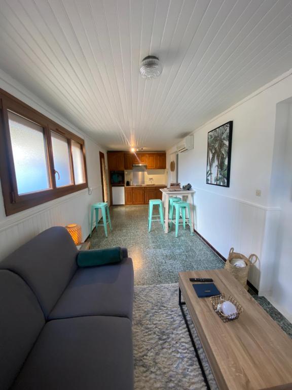 a living room with a couch and a table at Studio de la mer in La Croix-Valmer