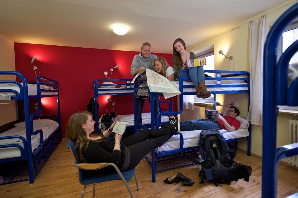 a group of people in a room with bunk beds at THE 4YOU Hostel & Hotel Munich in Munich