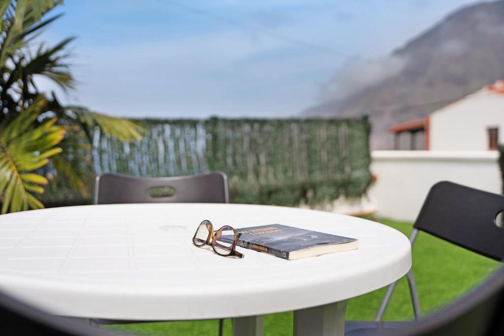 a pair of glasses sitting on a table with a book at Villa Luisa en Frontera in Tigaday