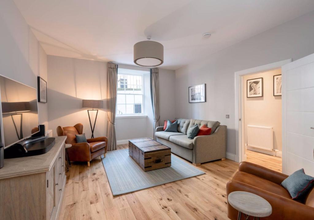 a living room with a couch and a table at Luxury apartment, Stafford Street in Edinburgh