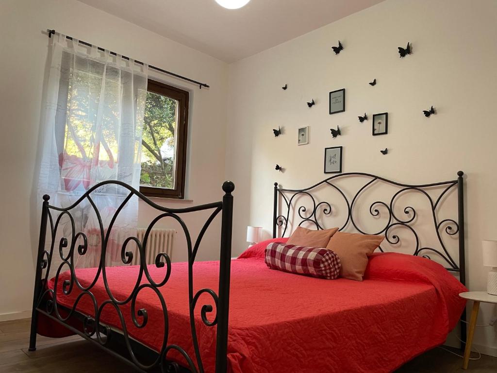 a bedroom with a red bed with a red comforter at Lake Apartment Ischia Red in Tenna 