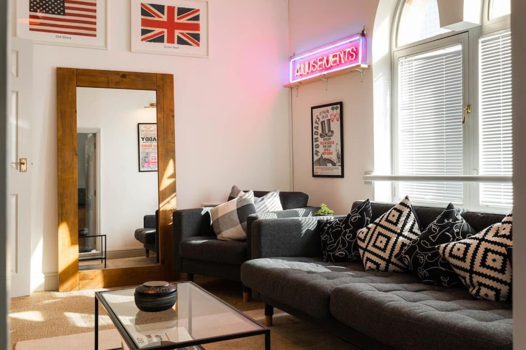 a living room with a couch and a flag on the wall at Church House Loft in Scarborough