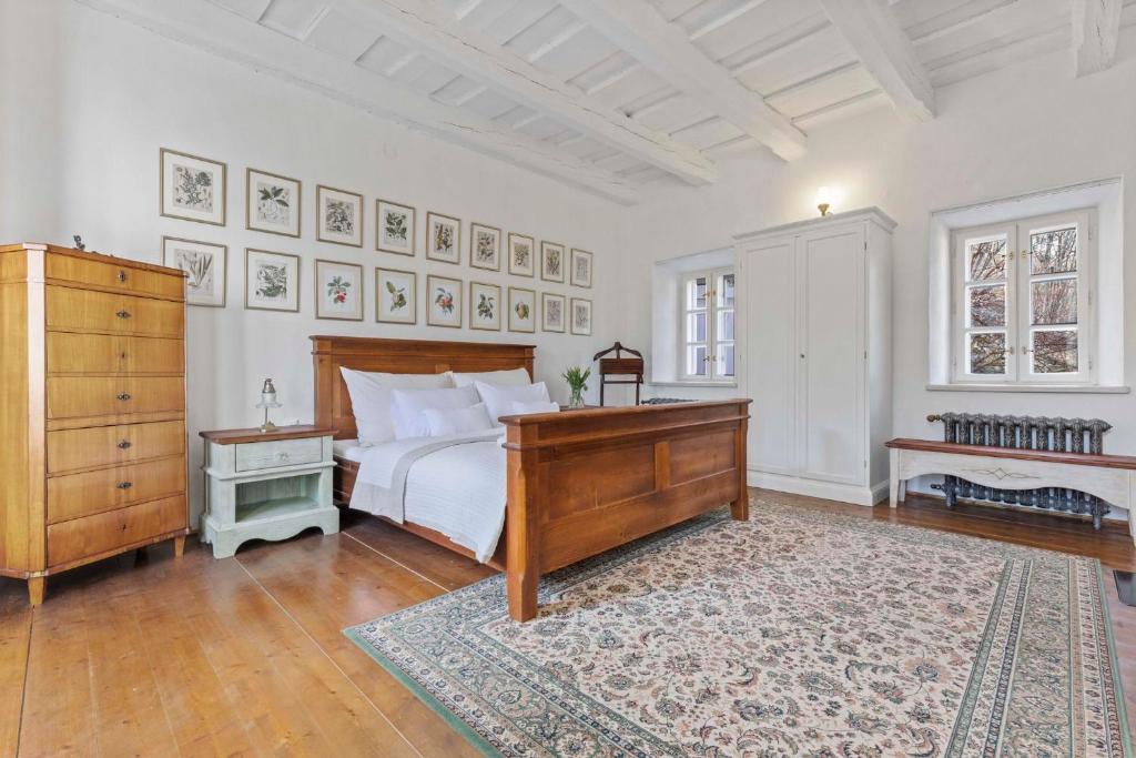 a bedroom with a bed and a dresser and a rug at Vila Štiavnica in Banská Štiavnica