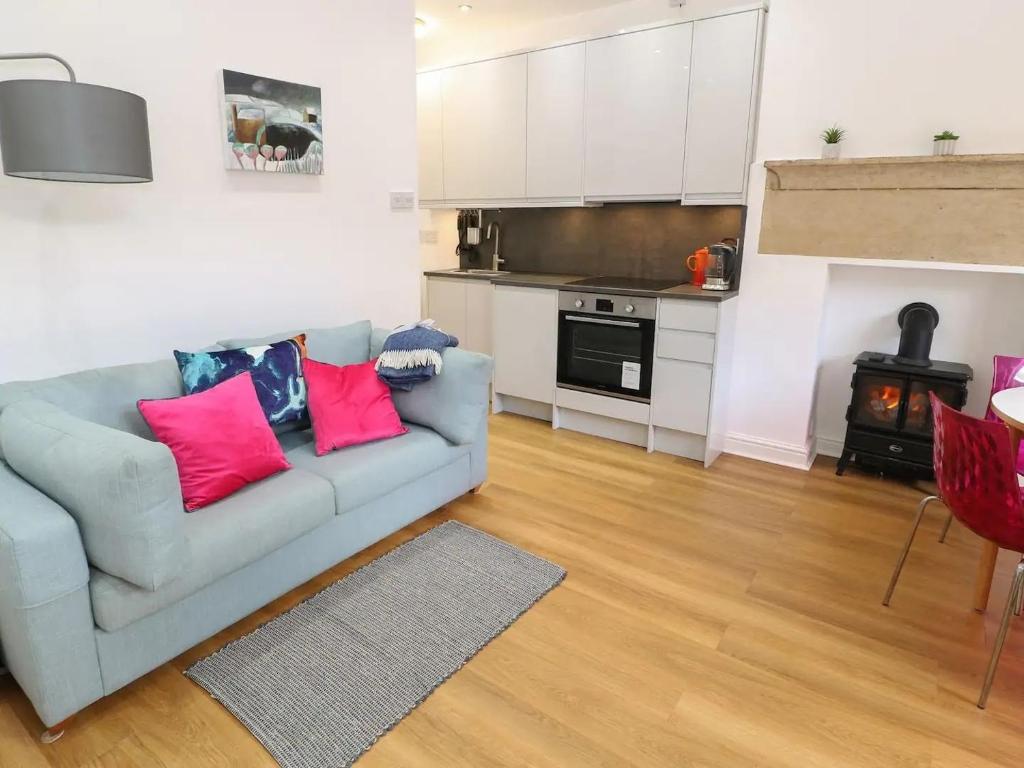 a living room with a couch and a kitchen at "Happy Valley Boutique Accomodation" Hotel Quality, Offering Free Parking in Hebden Bridge