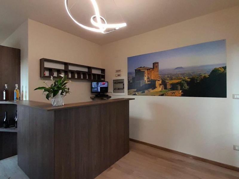 an office with a bar with a painting of a castle at Prealpina Hotel in Bagnolo Piemonte