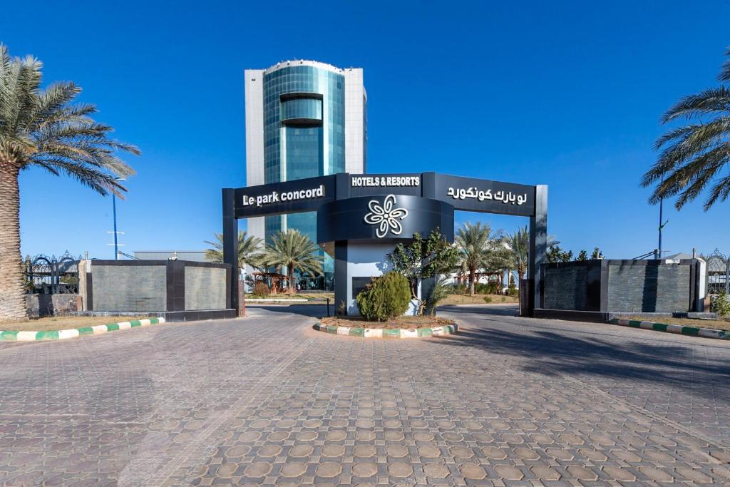 a building with a sign in the middle of a street at Le Park Concord - Sakaka in Sakakah