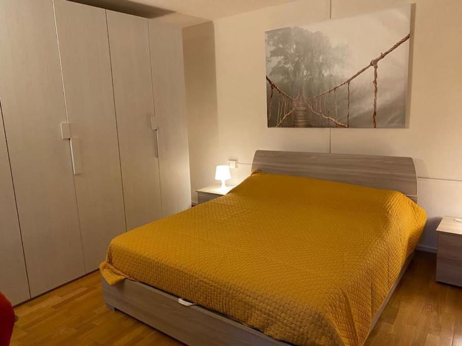 a bedroom with a bed with a yellow bedspread at Casa Luciana nel cuore dell'Alpe(022102-AT-849663) in Bertoldi