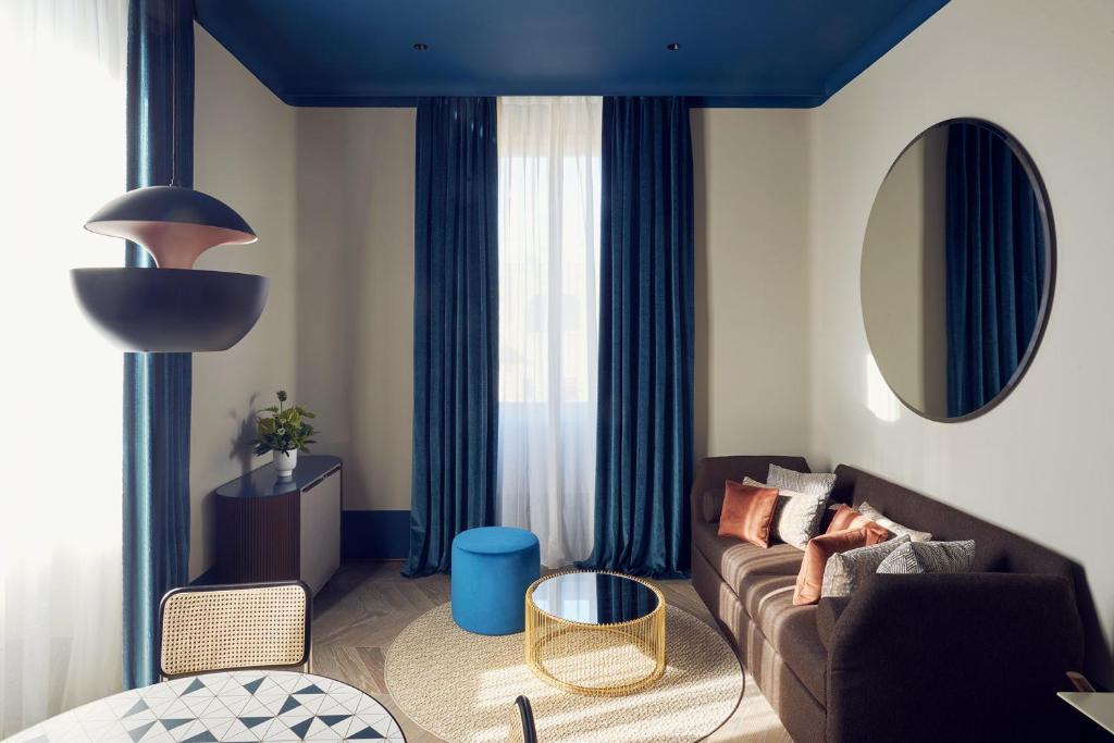uma sala de estar com um sofá e uma mesa em Palazzo Velabro, a Member of Design Hotels em Roma