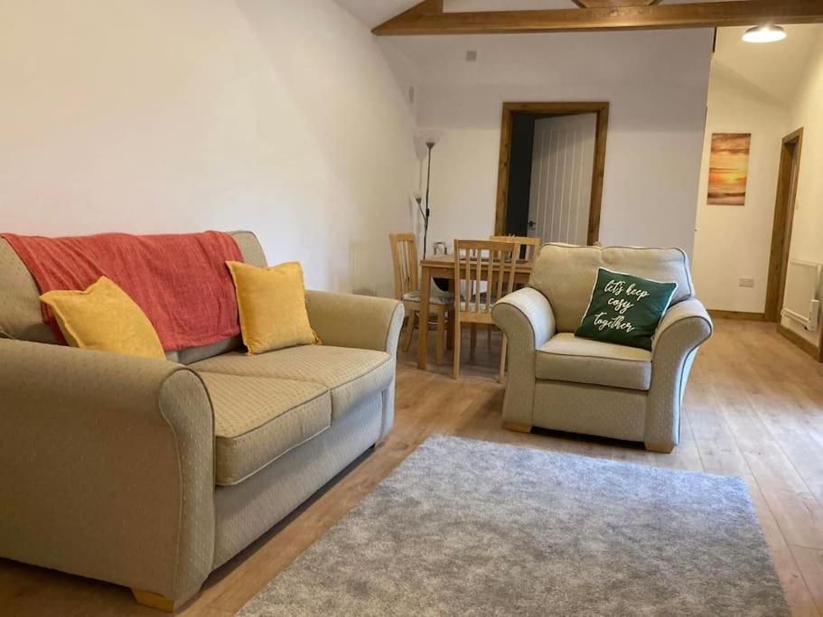 a living room with a couch and two chairs at The Panthouse Lodge in Felton