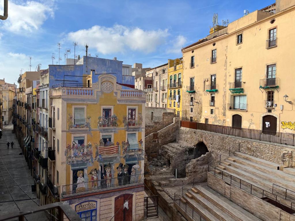 a group of buildings in a street with buildings at Apartamento Sedassos Circo Romano in Tarragona