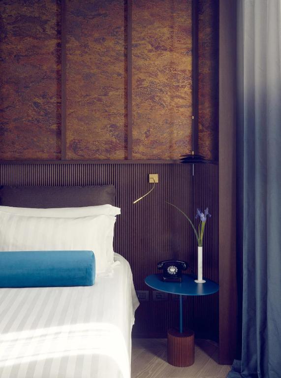Postel nebo postele na pokoji v ubytování Palazzo Velabro, a Member of Design Hotels