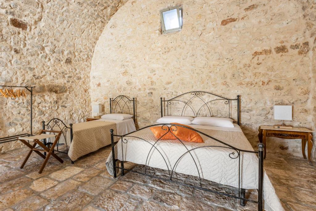 A bed or beds in a room at Antica Masseria San Benedetto