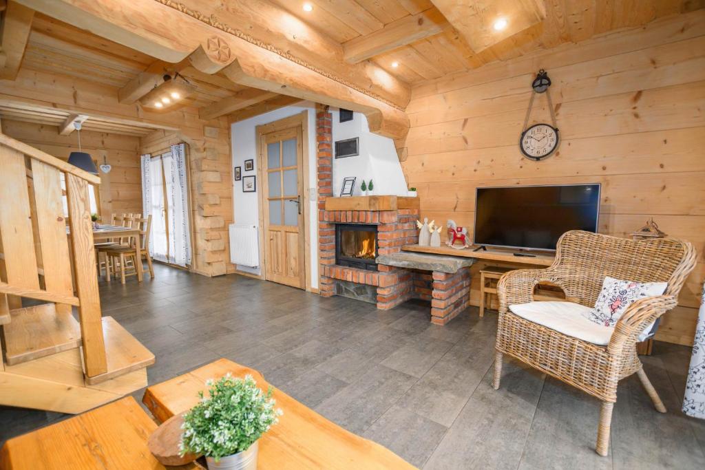 Cabaña de madera con sala de estar con chimenea en Zakopiańska Osada Domki, en Zakopane