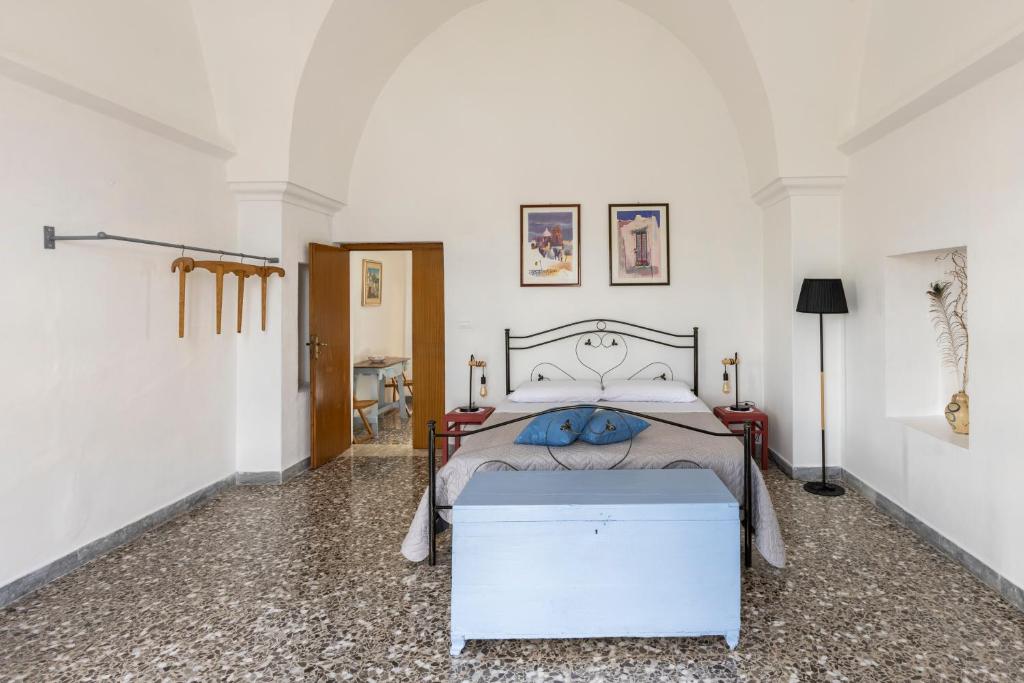 A bed or beds in a room at Antica Masseria San Benedetto