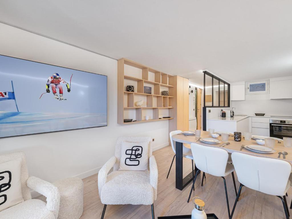 a dining room with a table and white chairs at Appartement Courchevel 1850, 3 pièces, 6 personnes - FR-1-564-80 in Courchevel