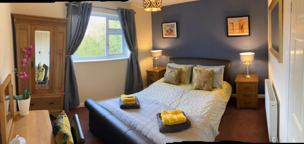 a bedroom with a bed with two boxes on it at Ogilvie Lodge in Llandudno Junction