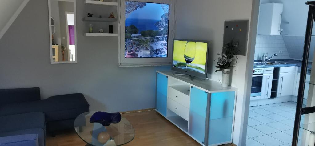 a living room with a tv on top of a cabinet at München großzügige Wohnung sehr ruhig in Munich