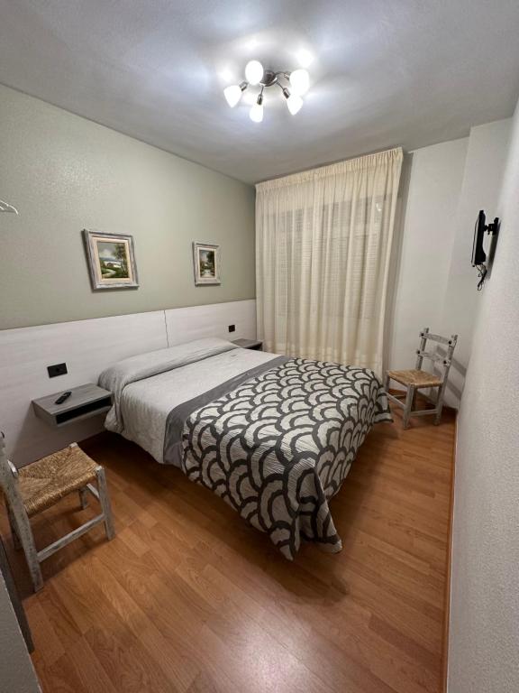 1 dormitorio con 1 cama y ventilador de techo en HOSTAL EL CHOCOLATERO, en Castildelgado
