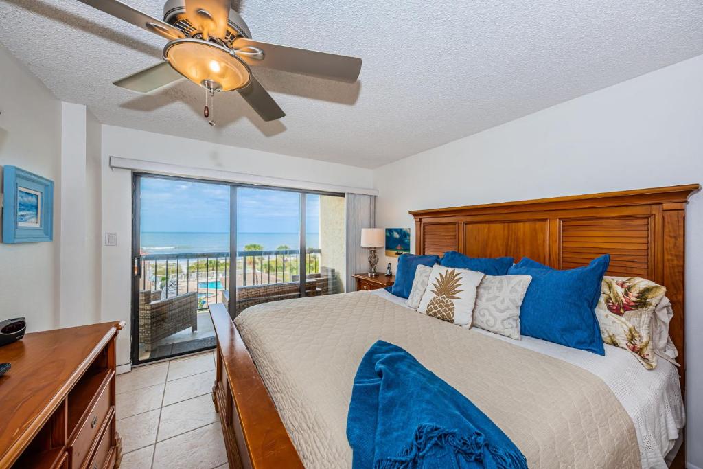a bedroom with a bed and a ceiling fan at Sandcastle North Unit #403 in Clearwater Beach