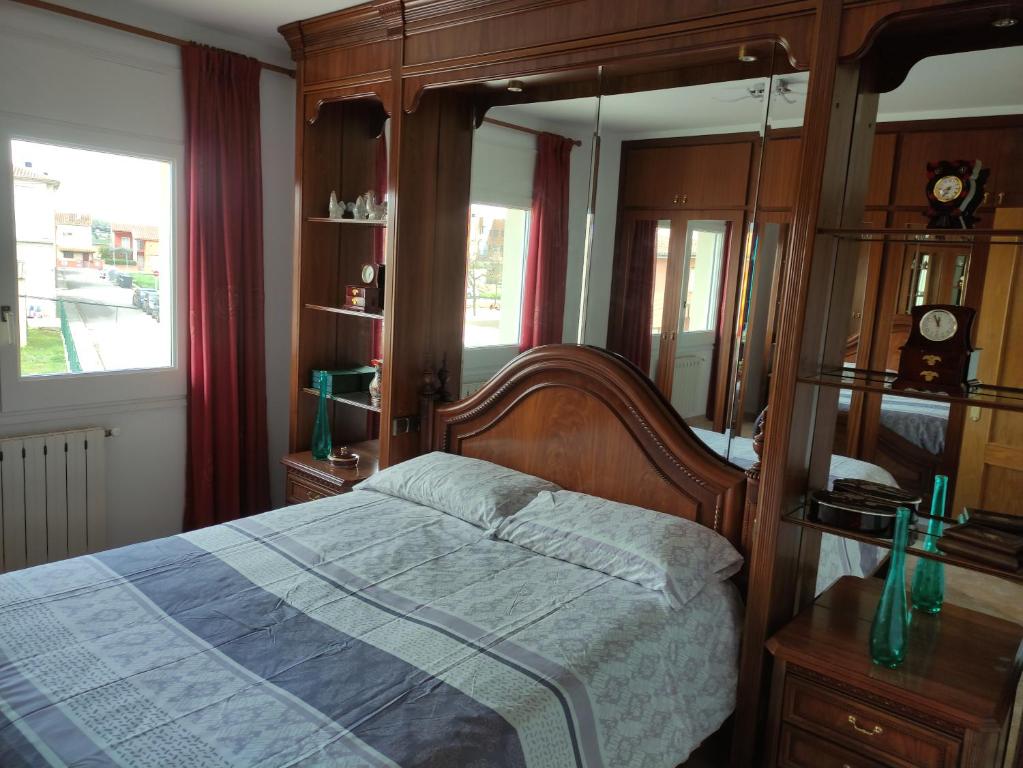 a bedroom with a bed and a large mirror at Casa Empordà con piscina exclusiva in Báscara