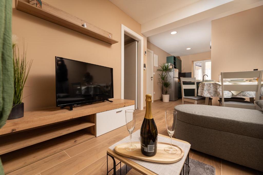 a living room with a bottle of wine on a table at Apartments Neptun in Baška