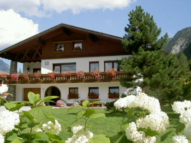 a large house with flowers in front of it at Ferienhaus Gapp in Elmen
