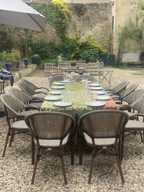 a long table with chairs and plates on it at La Maison Saint Joseph in Crépy-en-Valois