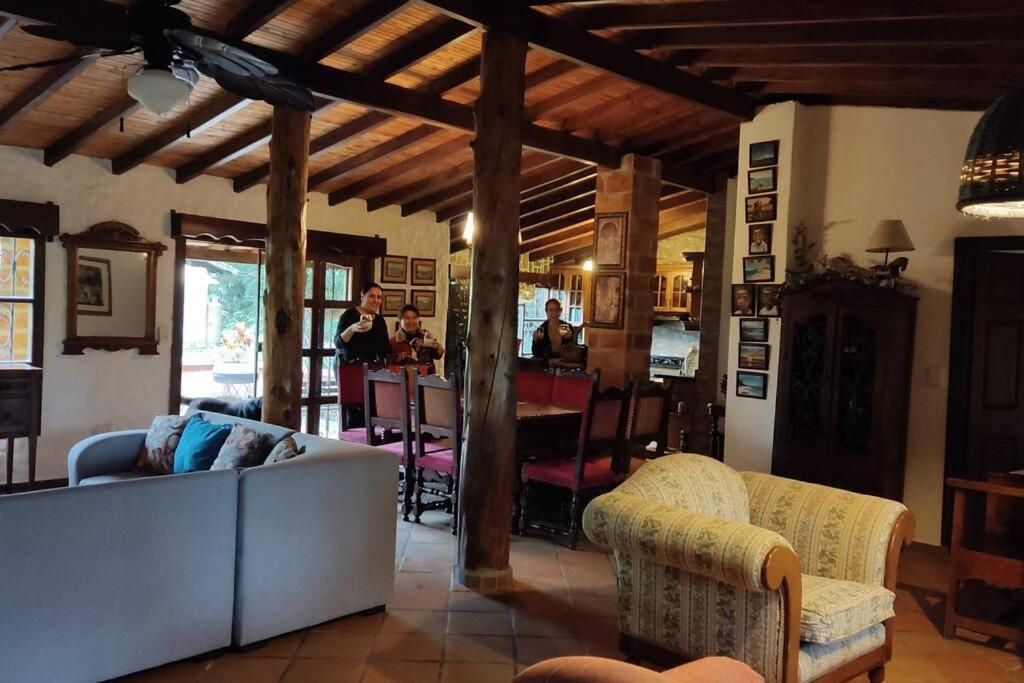 a living room with a couch and chairs and a bar at Finca exclusiva cerca a la reserva El Romeral in La Estrella