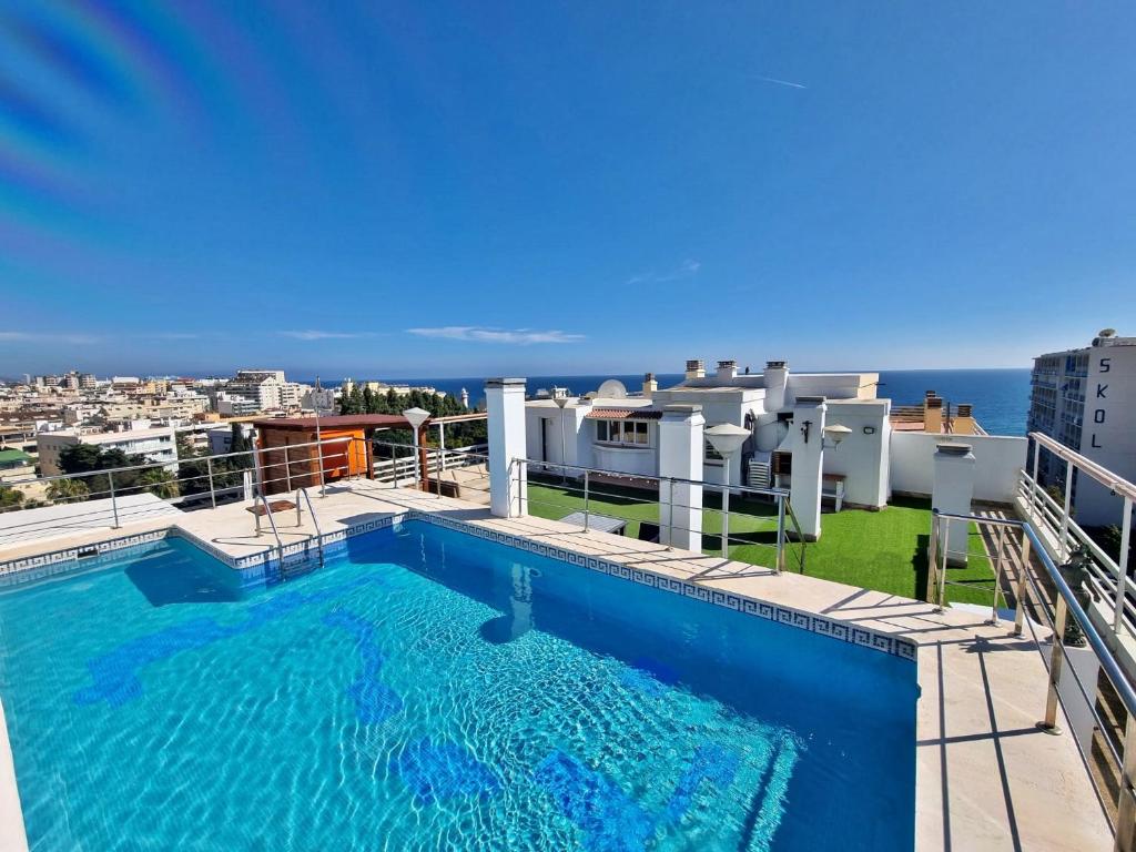 a swimming pool on the roof of a building at Penthouse with private pool, hot tub jacuzzi with sea views and chill-out zone, close to the sea in Marbella