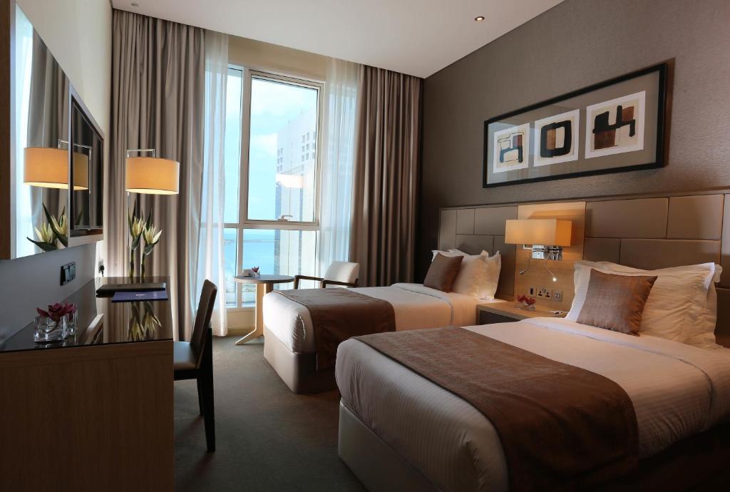 Postel nebo postele na pokoji v ubytování TRYP by Wyndham Abu Dhabi City Center